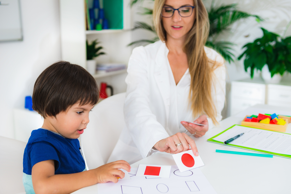 Photo of child learning with cards and shapes